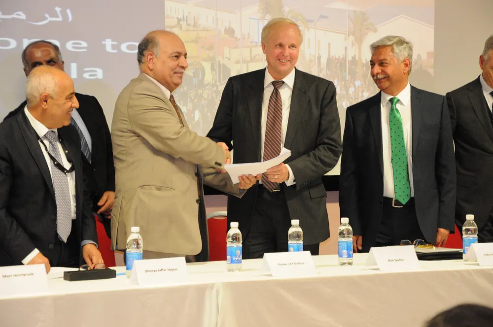 Done deal: BP chief executive Bob Dudley (fourth from left) was on hand at Rumaila as the revised deal was finalised