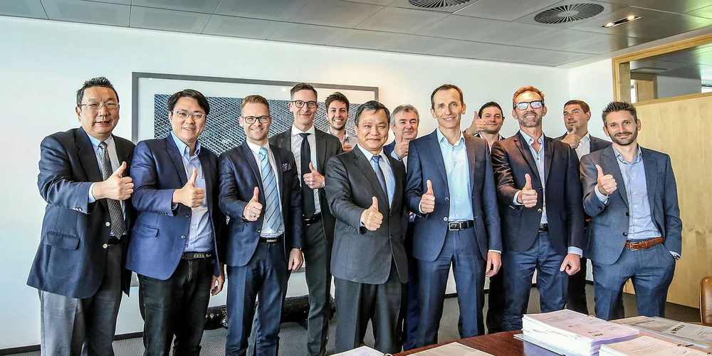 Teams from Jan De Nul and Formosa 1 celebrate the deal.