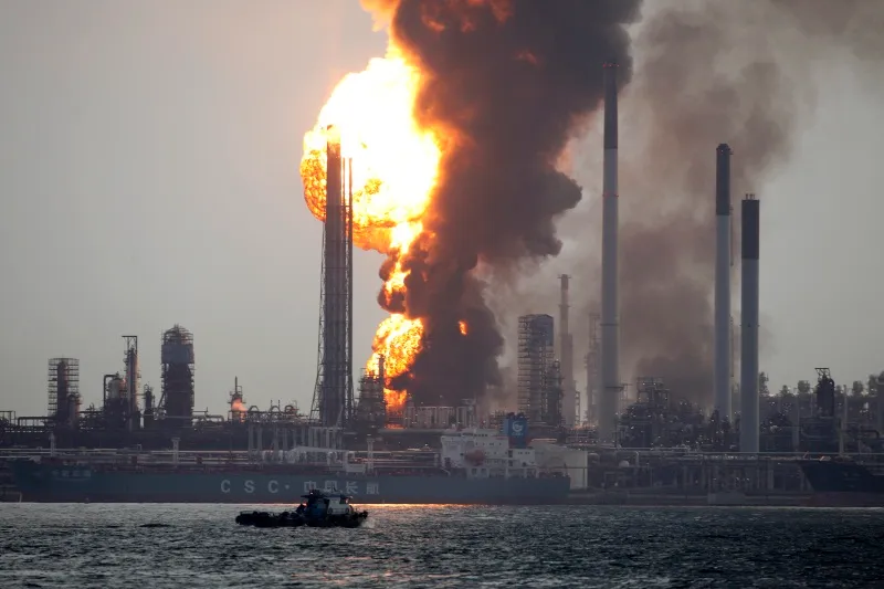 Pulau Bukom: authorities in Singapore have charged Shell in relation to the fire (above) that broke out at the 500,000 bpd offshore refinery last year