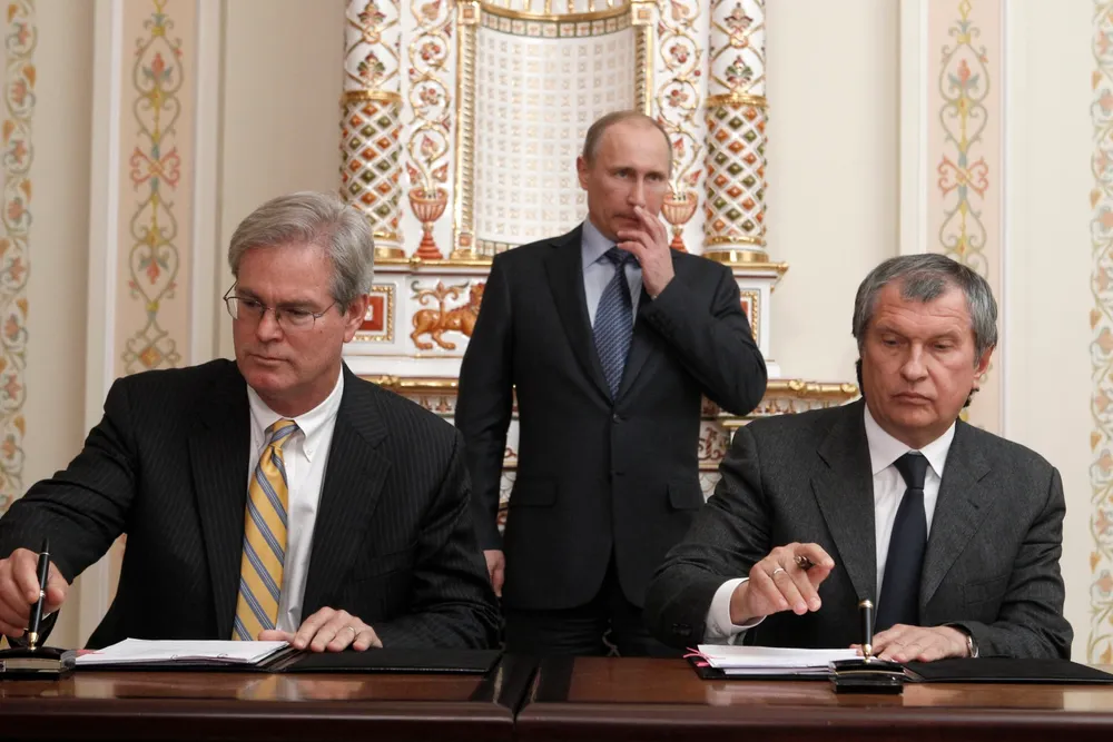 Rosneft president (right) signs deal documents with ExxonMobil Exploration president Stephen Greenlee earlier this year, with Russian President Vladimir Putin looking on