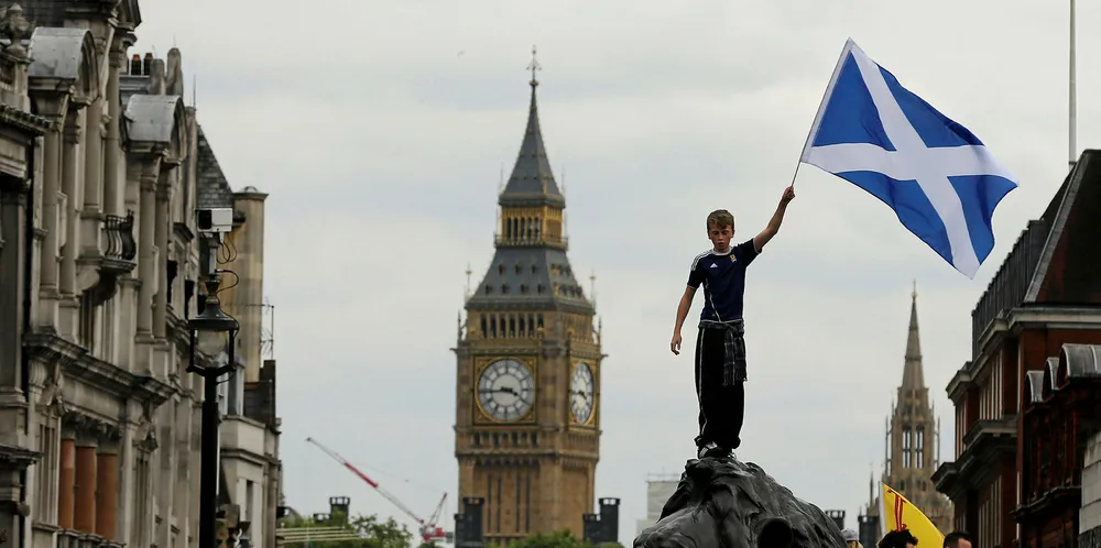 A boy waves a flag as Scotland fans gather in Trafalgar Square ahead of a friendly match against England.