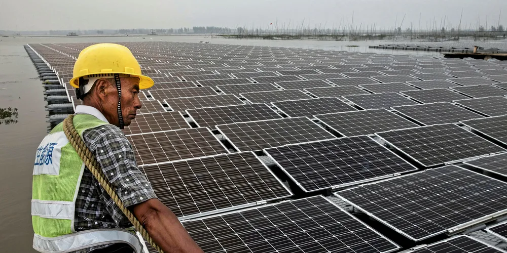 Chinese worker pulls floating PV panels