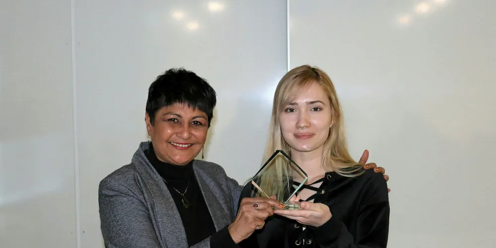GreenSeas Trust founding trustee Fazilette Khan (left) presents UEL student Laura Monica Carusato with the trophy for her winning beach bin design