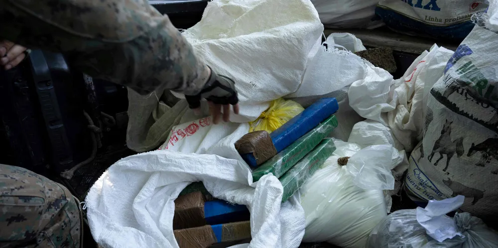 Military police guard cocaine seized during an operation against drug traffickers at the Rocinha favela in Rio de Janeiro, Brazil.