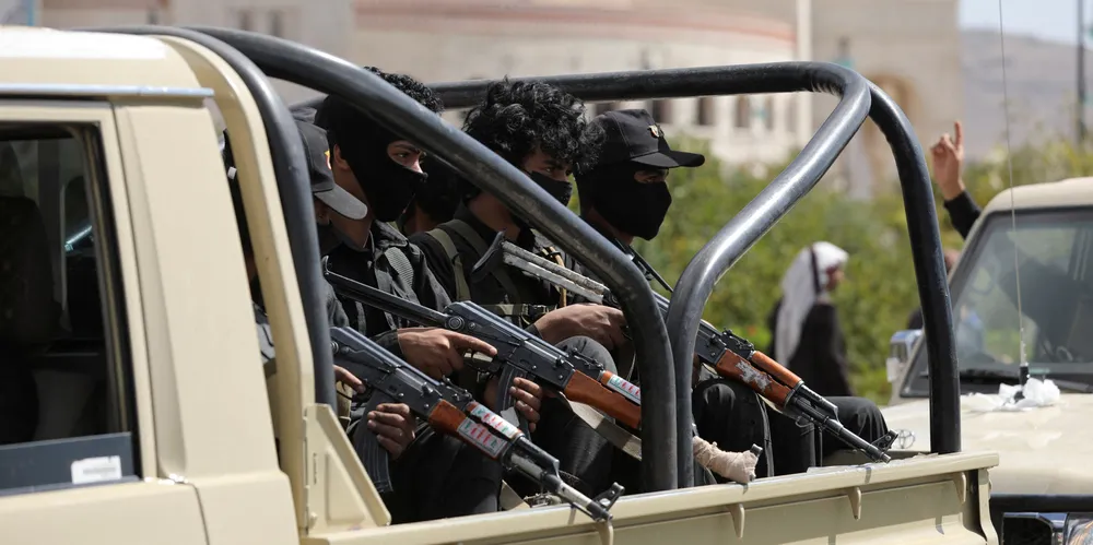 Houthi policemen ride on the back of a patrol pick-up truck during the funeral of Houthi fighters killed in US-led strikes, in Sanaa, Yemen.