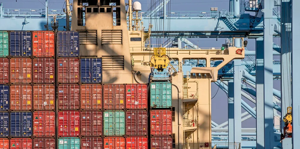 Stacked containers sit at the Port of Los Angeles. Container ship equities are getting a boost from disruption risk at the US ports of Los Angeles and Long Beach, an analyst said.