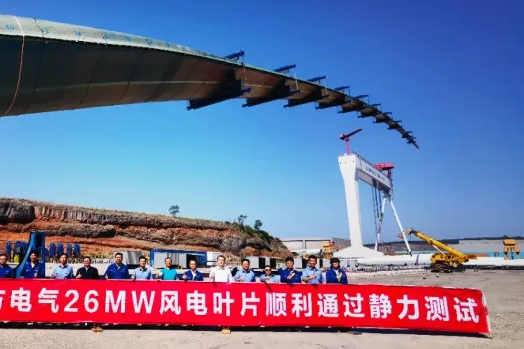 Workers celebrate the completion of the static test earlier this year on the ultra-sized blade.