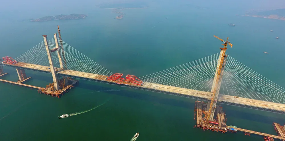 Aerial view of the last steel girder being lifted to complete the main span of the Fuzhou-Pingtan cross-strait highway-railway bridge under construction in Pingtan in southeast China's Fujian province.