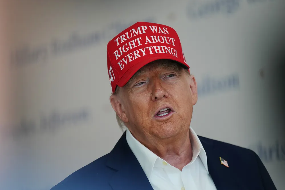 US President Donald Trump speaks to the media wearing his new favourite hat.