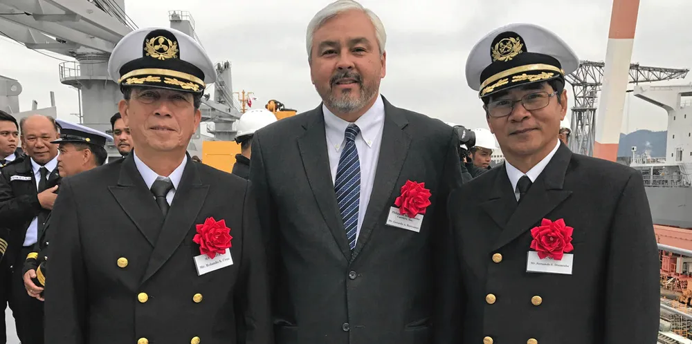 Gerardo Borromeo of Philippine Transmarine Carriers, flanked by trained officers on deck.