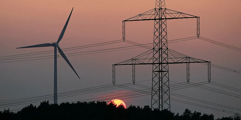 high-voltage transmission cables near a wind turbine in Germany