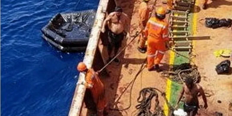 Crew from the Cetus are rescued by a passing cargo vessel.