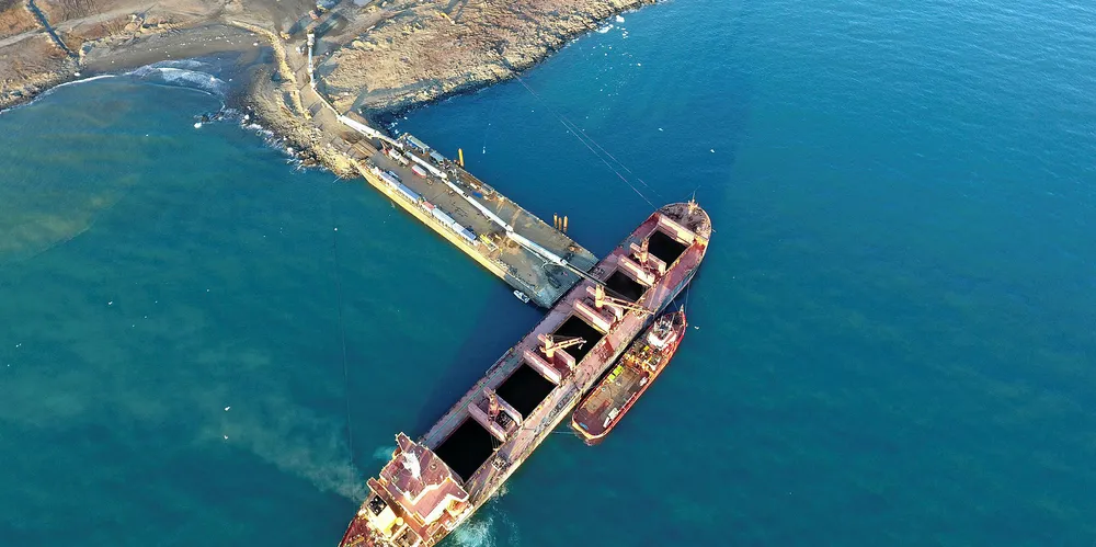 Pangaea's 43,000-dwt ice-class bulker Nordic Barents (built 1995) loads a cargo of ilmenite ore in the Moriusaq region in north-west Greenland via 'temporary port' using causeway and barge