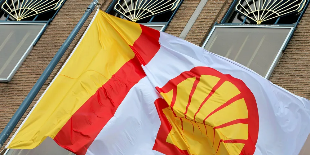 Flag bearing the company logo of Royal Dutch Shell outside its head office in The Hague, Netherlands