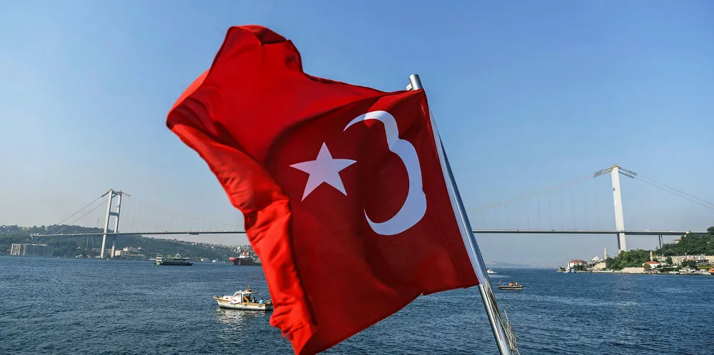 A Turkish national flag waves on Bosphorus river on July 22, 2018.
