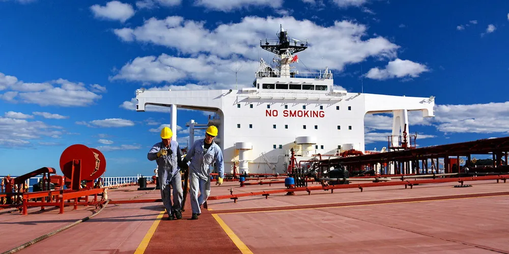 Seafarers work on board a tanker.