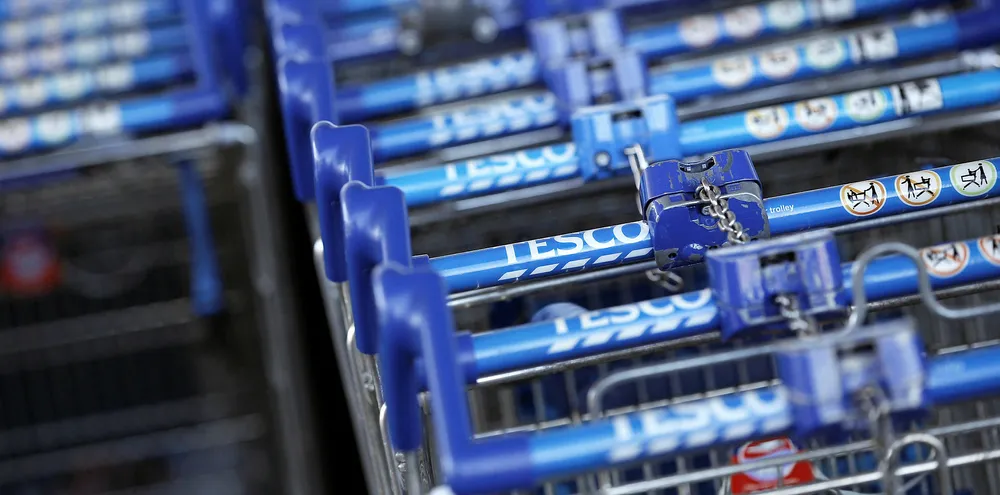 Shopping trolleys are pictured outside a Tesco supermarket in London