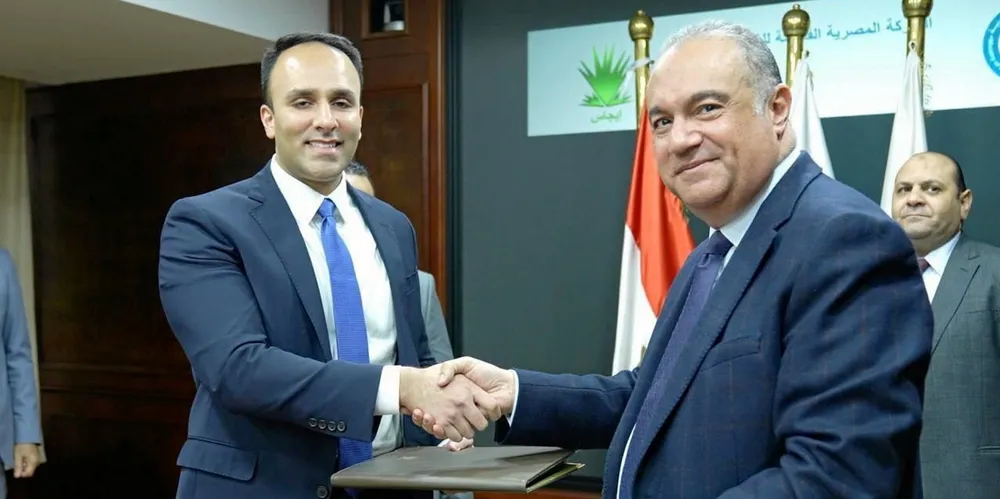 New Fortress Energy senior vice president, chartering and commercial shipping Asad Imran (left) seals the deal with EGAS executive managing director Yassin Mohamed (right).