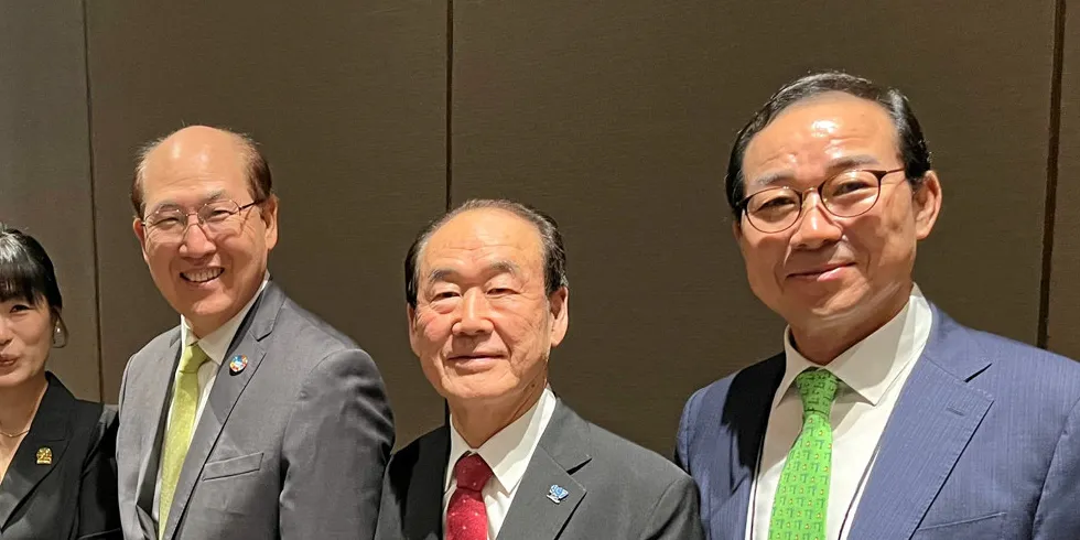 Sinokor president Tae Soon Chung (red tie, centre), stands next to former IMO secretary general Kitack Lim (left) at Korea Maritime Week in 2023.