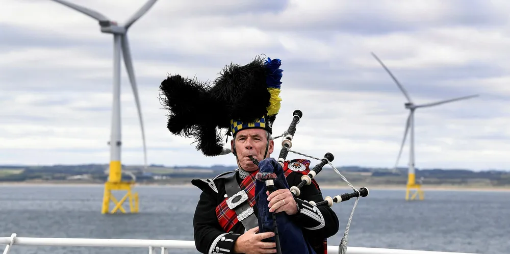 A piper performs at the opening of Scotland's European Offshore Wind Deployment Centre wind farm last September.