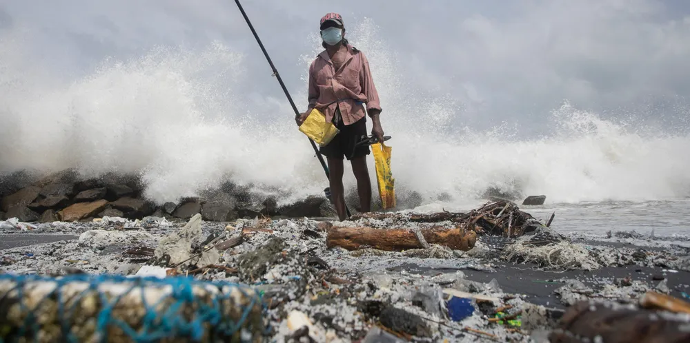 Kindston Jayalath fishes on a polluted Sri Lankan beach filled with plastic pellets washed ashore from the fire-damaged container ship X-Press Pearl. Photo: Scanpix