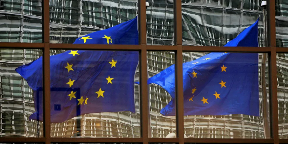 A European flag reflects 06 November 2007 in a building of the EU headquarters in Brussels. AFP PHOTO/DOMINIQUE FAGET