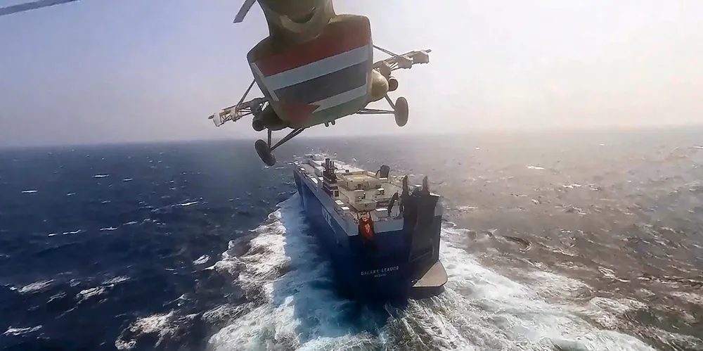 Houthi forces in a helicopter approach the Galaxy Leader.