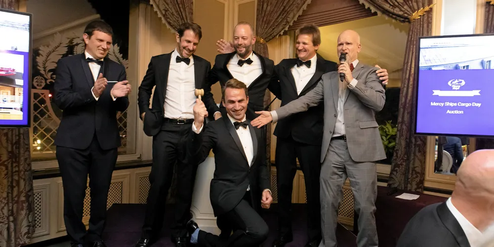 Winners of the Mercy Ships charity auction celebrate with auctioneer Benoit Repellin, front. From left to right: Eric Derhille, from Oryx Energies, the trading branch of Nyala Shipping; Cyril Ducau, Eastern Pacific Shipping; Olivier Dechoux, Augusta Energy; Gilbert Walter, BRS; Bryce Wagner, Mercy Ships.