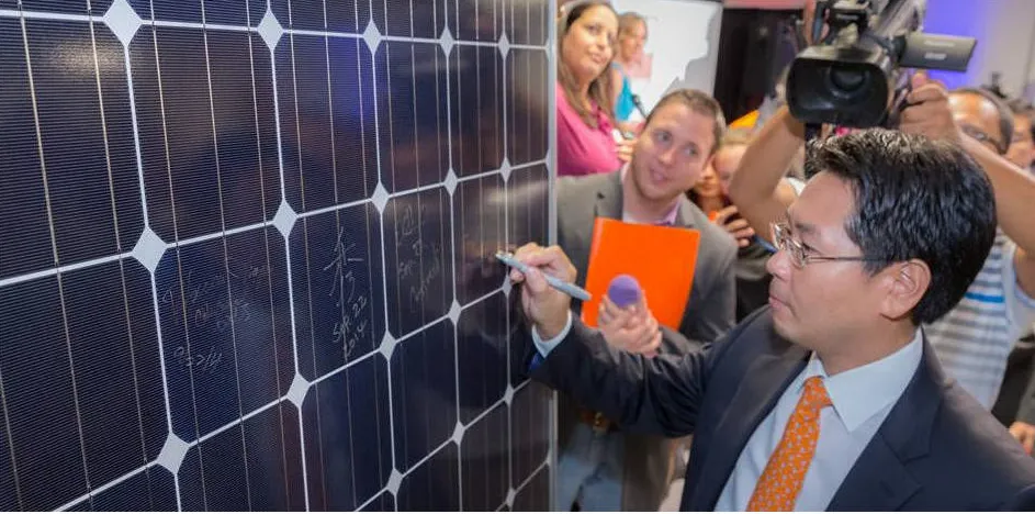 Mission Solar Energy chief executive Alex Kim adds his good wishes at company's new solar panel plant.