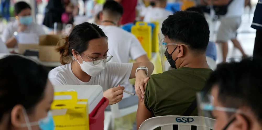 A man is inoculated with China's Sinovac Covid-19 vaccine in Quezon city, Philippines on Monday.