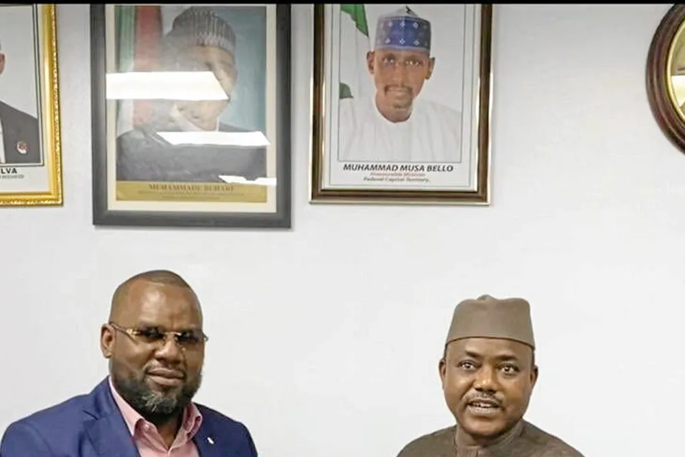 Driving force: UTM Offshore chief executive Julius Rone (left) receives an FLNG licence from Sarki Auwalu, chief executive of Nigeria’s Department of Petroleum Resources, in March 2021