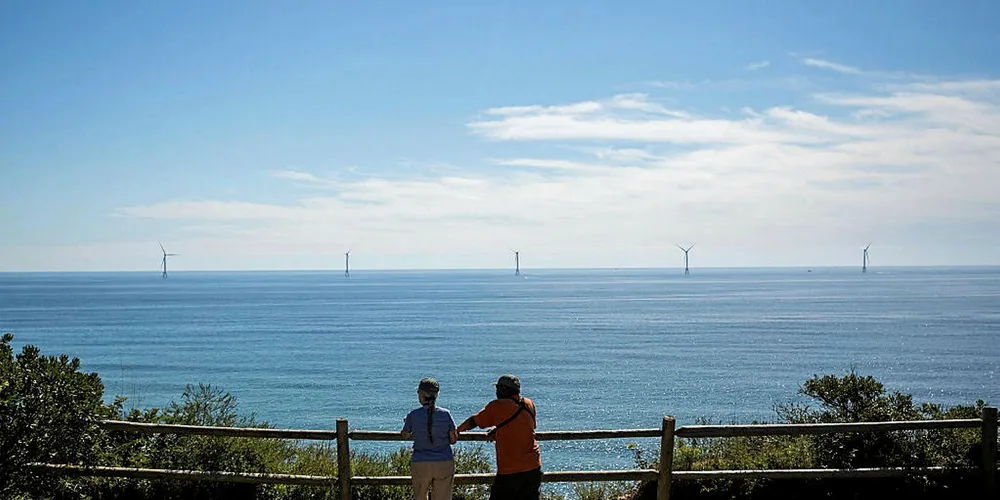 Tourists on Block Island gaze out at the first US offshore wind farm. (Photo by Scott Eisen/Getty Images)