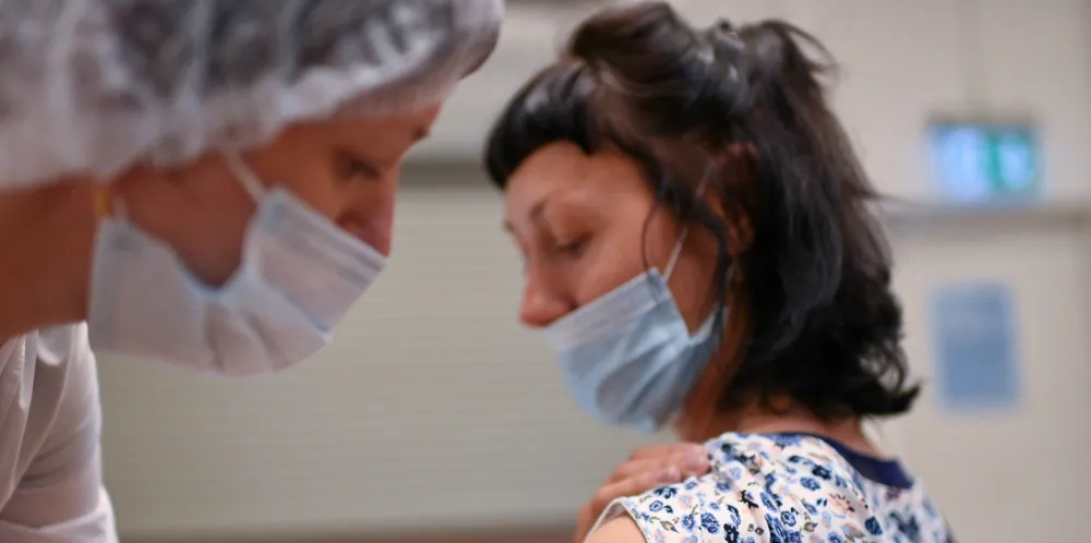 A woman receives a dose of Russia's Sputnik V vaccine against Covid-19 in a vaccination centre at a shopping mall in Omsk. The country is a leading supplier of seafarer labour, but it is still struggling to vaccinate its population.