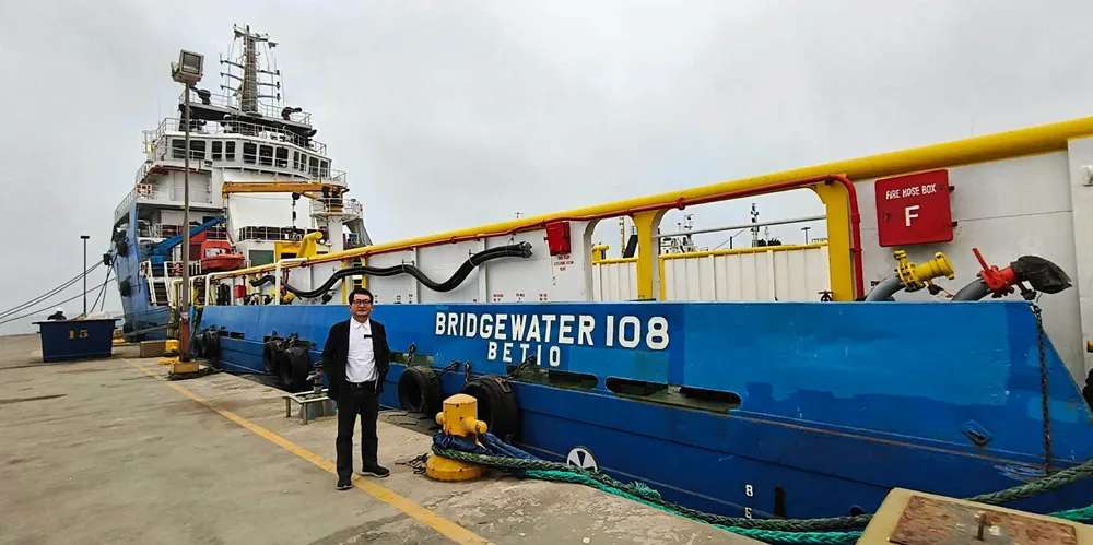 Kim Heng executive chairman and chief executive Thomas Tan in front of the 2012-built AHTS Bridgewater 108, one of the vessels in the Bridgewater Offshore fleet.