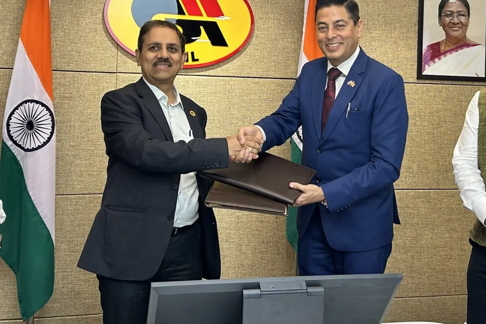 Gail and Oil India officials sign 15-year gas supply deal.