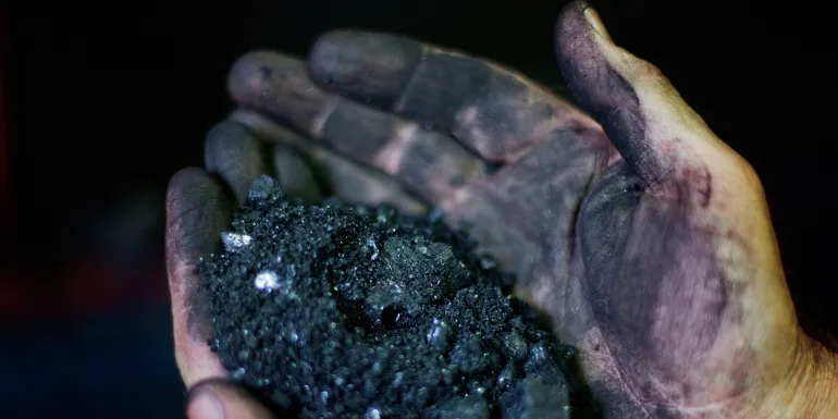 Miner holds coal in Welch, West Virginia