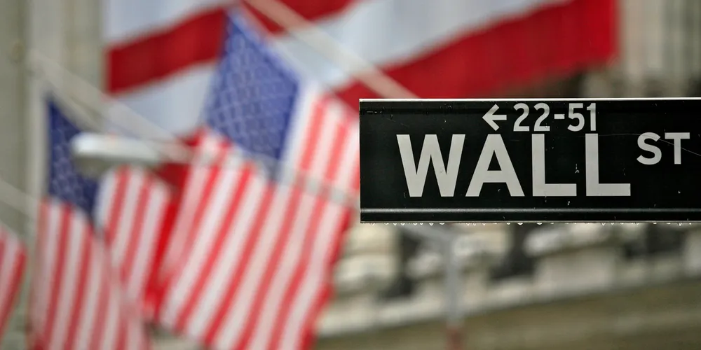 Rain drips from the Wall Street sign outside the New York Stock Exchange.
