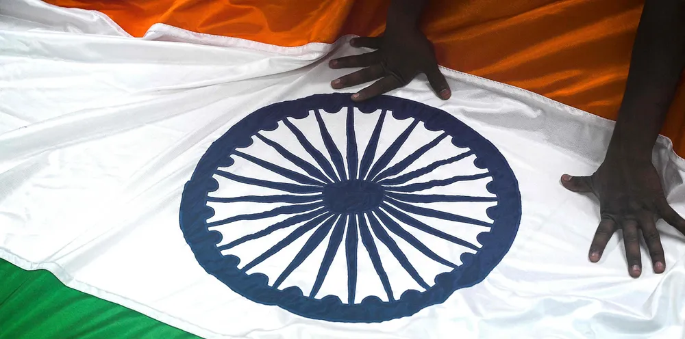 A worker checks India’s national flag at a workshop in Mumbai.