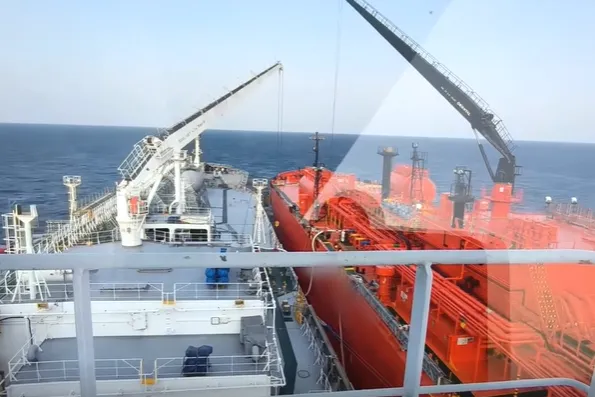 A screenshot of a promotional video on Exmar's LinkedIn showing the ship-to-ship transfer of ammonia