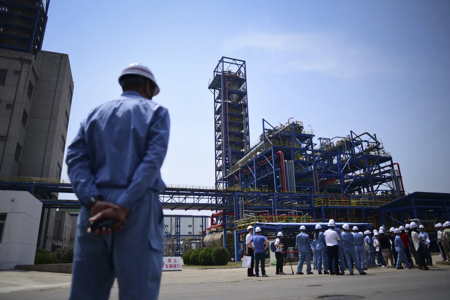 A Sinopec employee looks at a group of visitors at the Yanshan petrochemical plant in Beijing, which is expected to be the end point for the newly approved pipeline.
