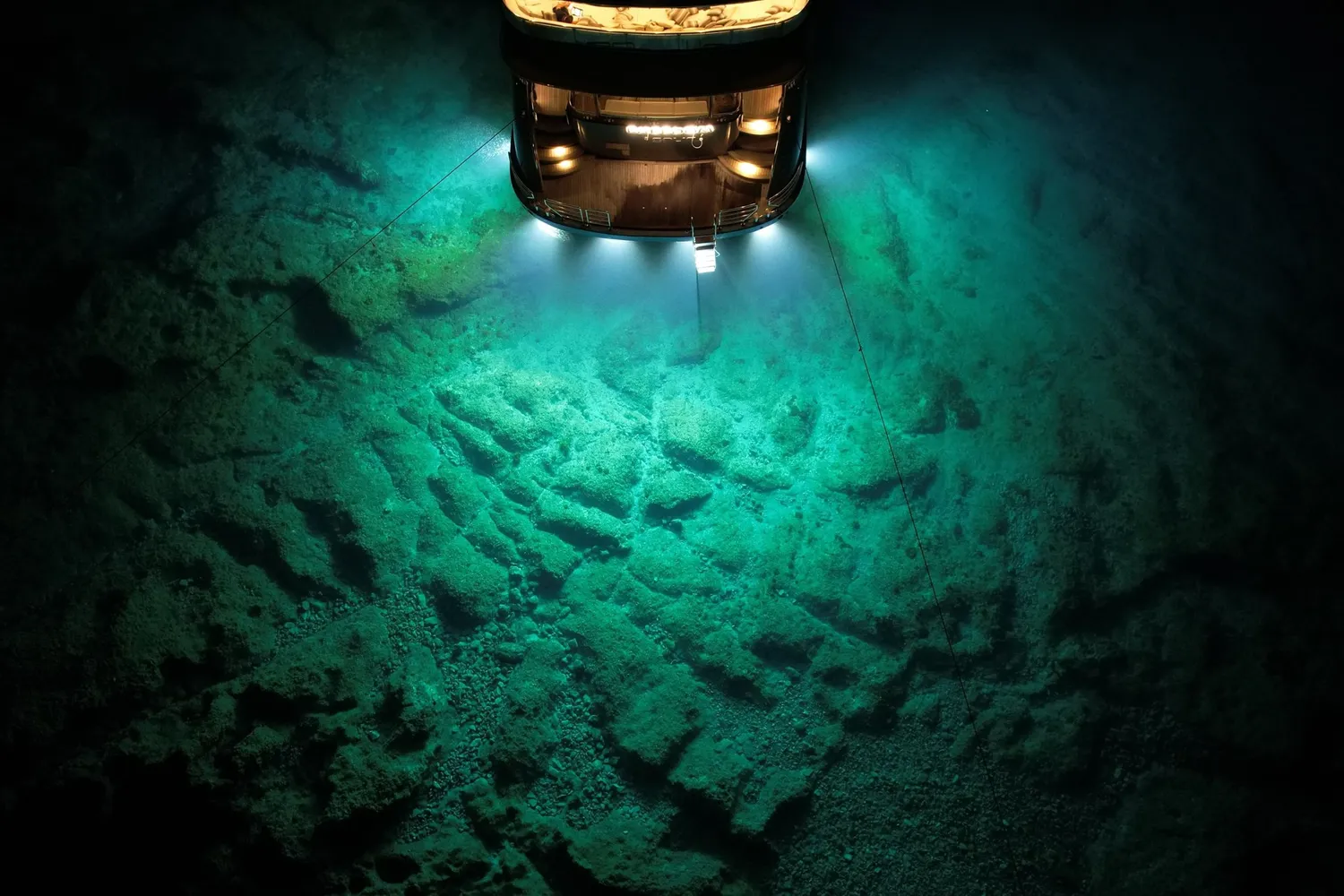 A stock image of a submersible shining a light onto the seafloor